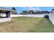 Spacious backyard featuring an enclosed patio, white vinyl fence and a fire pit at 1060 Colony Park Dr, Lakeland, FL 33813