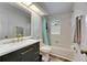 Bright bathroom showcasing modern black vanity, brushed gold hardware, and shower-tub combo at 1060 Colony Park Dr, Lakeland, FL 33813