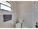 Bathroom featuring a standard toilet, towel bar, and a window for natural light at 1060 Colony Park Dr, Lakeland, FL 33813