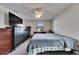 Bright bedroom featuring a ceiling fan, carpeted floor, and dark-stained dressers for ample storage at 1060 Colony Park Dr, Lakeland, FL 33813