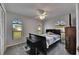 Bedroom featuring a bed, two arched windows, carpeted floor, and a ceiling fan at 1060 Colony Park Dr, Lakeland, FL 33813