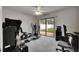 Exercise equipment and office setup in bonus room with sliding glass doors at 1060 Colony Park Dr, Lakeland, FL 33813