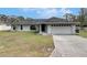Charming single-story home featuring a well-maintained lawn, long driveway, and two-car garage at 1060 Colony Park Dr, Lakeland, FL 33813