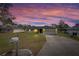 Charming single-story home featuring a well-maintained lawn, long driveway, and two-car garage at 1060 Colony Park Dr, Lakeland, FL 33813