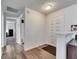 Welcoming foyer with light walls and wood-look flooring, leading to a bedroom and additional rooms at 1060 Colony Park Dr, Lakeland, FL 33813