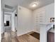 Inviting foyer with hardwood floors, a decorative white door, and a view into other rooms at 1060 Colony Park Dr, Lakeland, FL 33813