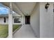 Inviting front porch with covered walkway featuring decorative columns that leads to a wooden front door at 1060 Colony Park Dr, Lakeland, FL 33813