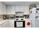 Bright kitchen featuring white cabinets, countertops, and appliances, plus a white oven at 1060 Colony Park Dr, Lakeland, FL 33813