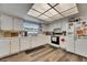 Spacious kitchen featuring white cabinets, wood-look floors, and appliances at 1060 Colony Park Dr, Lakeland, FL 33813