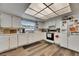 Bright kitchen featuring white cabinets, countertops and appliances, plus modern flooring and lighting at 1060 Colony Park Dr, Lakeland, FL 33813