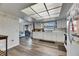 Bright kitchen boasts wood floors, white cabinets, window, and modern lighting at 1060 Colony Park Dr, Lakeland, FL 33813