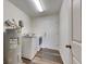 A laundry room featuring a washer, dryer, and water heater, complete with wood-look flooring at 1060 Colony Park Dr, Lakeland, FL 33813