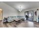 Cozy living room with wood floors, comfortable sofa, and access to the backyard at 1060 Colony Park Dr, Lakeland, FL 33813