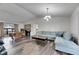 Open living room with wood floors, vaulted ceiling, modern light, and large sofa at 1060 Colony Park Dr, Lakeland, FL 33813