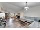 Large living room with wood floors, vaulted ceilings, modern light fixture, and sofa at 1060 Colony Park Dr, Lakeland, FL 33813