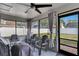 Relaxing screened patio with ceiling fan, neutral decor, and view of fenced backyard at 1060 Colony Park Dr, Lakeland, FL 33813