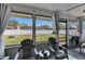 Outdoor patio with chairs, view of grassy backyard, and surrounding privacy fence at 1060 Colony Park Dr, Lakeland, FL 33813