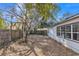 Backyard with a wooden fence, mature tree with hanging moss, providing a private and natural outdoor space at 116 Woodlane Ave, Wildwood, FL 34785