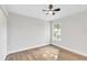 Well-lit bedroom featuring wood floors and a bright window, creating a comfortable and inviting atmosphere at 116 Woodlane Ave, Wildwood, FL 34785