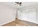 Cozy bedroom featuring wood floors, closet with sliding doors, and ensuite bathroom at 116 Woodlane Ave, Wildwood, FL 34785