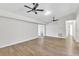 Bright living room featuring new floors, freshly painted walls, and modern ceiling fans, creating a welcoming atmosphere at 116 Woodlane Ave, Wildwood, FL 34785