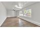 Bright living room featuring wood floors, ample natural light, and modern ceiling fans at 116 Woodlane Ave, Wildwood, FL 34785