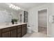 Bathroom featuring double sinks, ample counter space, and an adjacent walk-in closet at 9064 Wildlight Trl, Wildwood, FL 34785