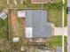 Aerial view of backyard with patio, shed, perimeter fence, and mature landscaping at 610 Moonpenny Cir, Port Orange, FL 32127