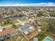 Aerial view of a single-Gathering home in a residential neighborhood with mature trees and well-maintained lawns at 610 Moonpenny Cir, Port Orange, FL 32127