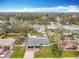 An aerial view shows the home in a well-established neighborhood and spacious lawns with mature trees at 610 Moonpenny Cir, Port Orange, FL 32127