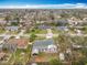 Aerial view of a home in a residential neighborhood with lush trees, green lawns, and tree-lined streets at 610 Moonpenny Cir, Port Orange, FL 32127