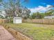 Expansive backyard with a well-kept lawn, a storage shed, and a charming brick-lined walkway enhancing the outdoor space at 610 Moonpenny Cir, Port Orange, FL 32127