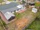 Aerial view of the home's expansive backyard featuring a storage shed and screened-in patio at 610 Moonpenny Cir, Port Orange, FL 32127