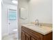 Bathroom featuring a wood vanity with a bright countertop, sink, mirror and fixtures at 610 Moonpenny Cir, Port Orange, FL 32127