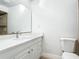 Bathroom featuring a white vanity with a sink and mirror, as well as a toilet at 610 Moonpenny Cir, Port Orange, FL 32127