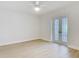 Bedroom featuring a light colored walls and floors and decorative glass pane doors at 610 Moonpenny Cir, Port Orange, FL 32127