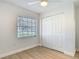 Bedroom featuring light colored walls and floors, a ceiling fan, and a built-in closet at 610 Moonpenny Cir, Port Orange, FL 32127