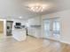 Modern kitchen with white cabinets, stainless appliances, island, hardwood floors and access to living area at 610 Moonpenny Cir, Port Orange, FL 32127