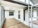 Relaxing sunroom featuring tile flooring, white siding, and screened windows, perfect for enjoying natural light and outdoor views at 610 Moonpenny Cir, Port Orange, FL 32127