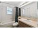 Well-lit bathroom with shower-tub combo, tile surround, and modern vanity at 8867 Pebblebrooke Dr, Lakeland, FL 33810