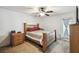 Cozy bedroom with ceiling fan and wood frame bed with side door access at 8867 Pebblebrooke Dr, Lakeland, FL 33810