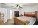 Bedroom featuring a ceiling fan and a wooden frame bed with red pillows at 8867 Pebblebrooke Dr, Lakeland, FL 33810