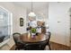 Dining area with a view of the living room and kitchen, accentuated by natural light at 8867 Pebblebrooke Dr, Lakeland, FL 33810