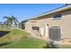 Home exterior featuring a well-manicured lawn and various utility units at 8867 Pebblebrooke Dr, Lakeland, FL 33810