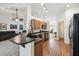 Open kitchen with wood cabinets, laminate counters, and black appliances at 8867 Pebblebrooke Dr, Lakeland, FL 33810