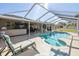 Relaxing screened-in pool with lounge chairs and an outdoor kitchen perfect for sunny days at 8867 Pebblebrooke Dr, Lakeland, FL 33810