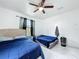 Bright bedroom featuring two beds, white walls, and a modern ceiling fan at 3911 Auburndale Ave, Orlando, FL 32839