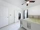 Bedroom view featuring tile floors, ceiling fan, closet, and window with curtains at 3911 Auburndale Ave, Orlando, FL 32839