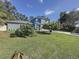 Well-manicured lawn and a two-story home with attached two car garage at 3911 Auburndale Ave, Orlando, FL 32839