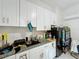 Kitchen area with white cabinetry, granite counters, and modern appliances at 3911 Auburndale Ave, Orlando, FL 32839